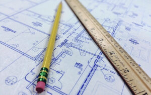 a ruler and pencil on top of blueprint