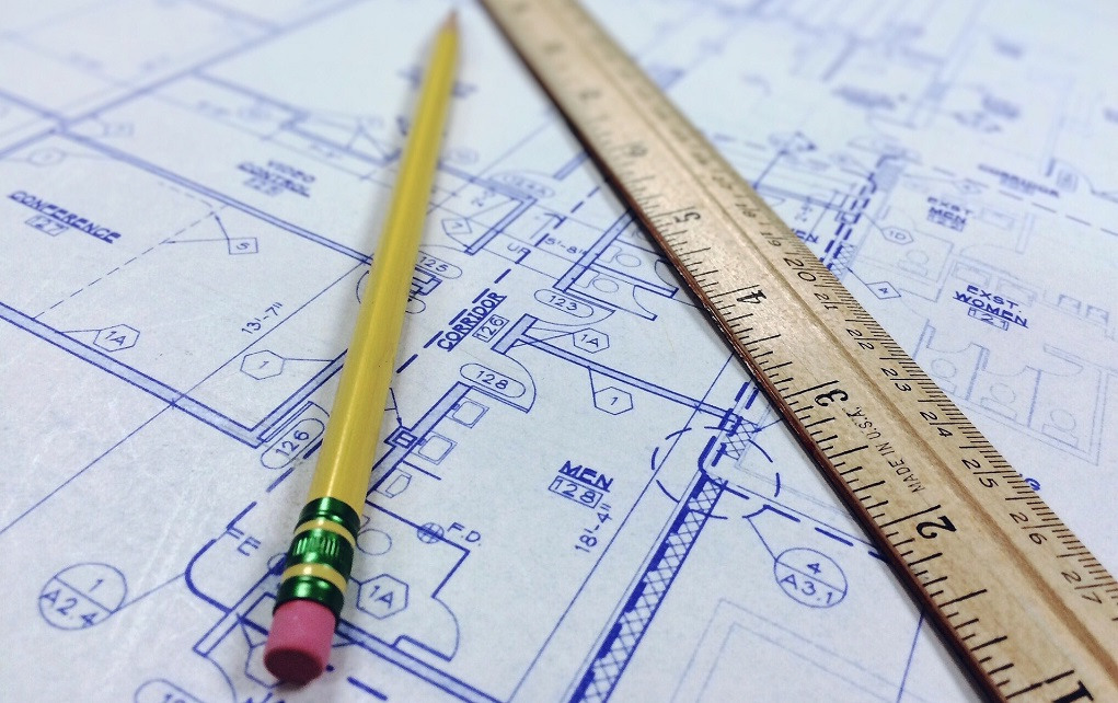 a ruler and pencil on top of blueprint