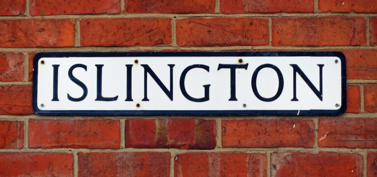 a street sign on a brick wall