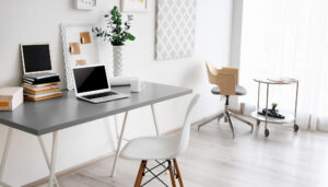 a white desk with a laptop and a chair