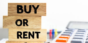 a wooden block with the words buy or rent on it
