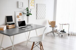 a white desk with a laptop on it