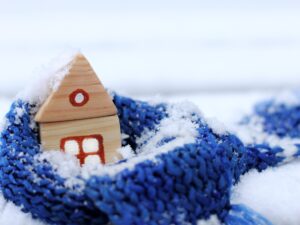a small wooden house in the snow