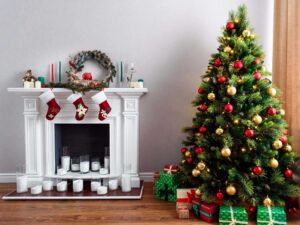 a christmas tree in a living room with a fireplace