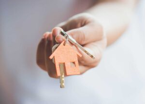 a woman holding a house key