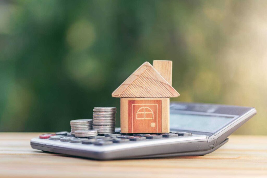 a calculator and a house on a table