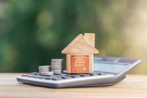 a calculator and a house on a table