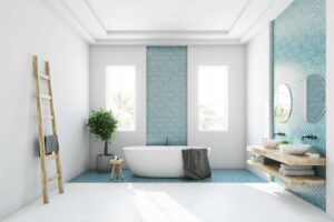 a bathroom with a blue tile wall and a white tub