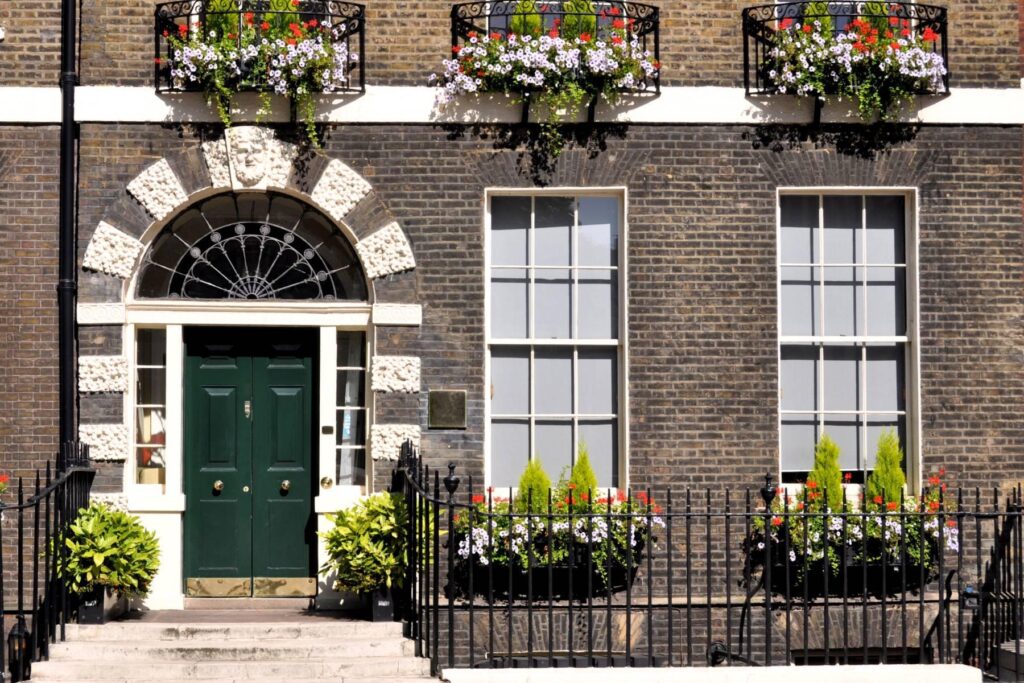a building with a green door and windows