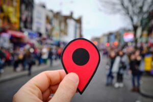 a person holding a red marker in the middle of a street