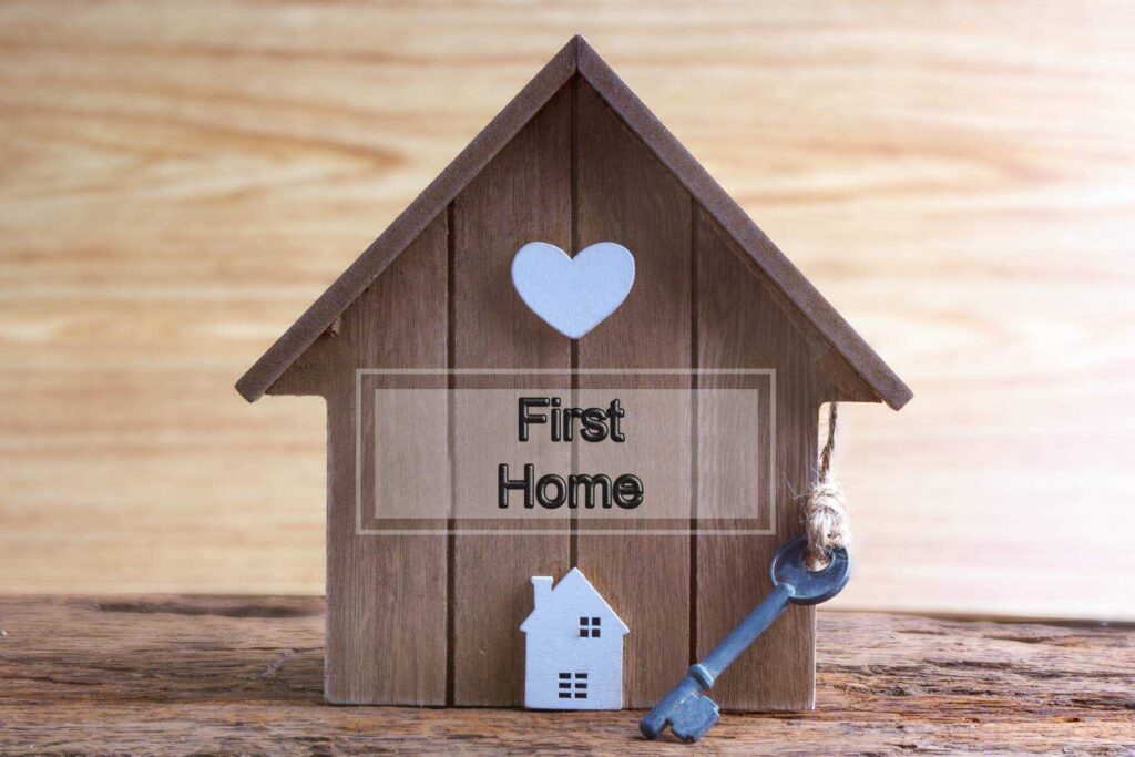 a small wooden birdhouse with a heart on it