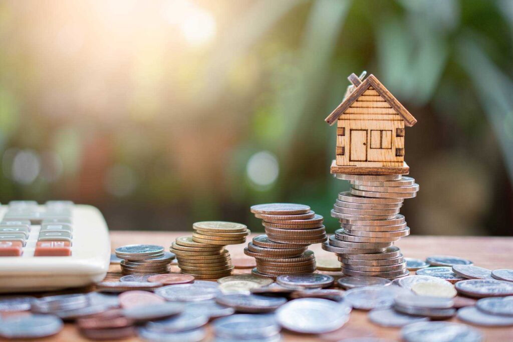 a house and coins on a table