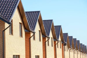 a row of houses with solar panels on the roof