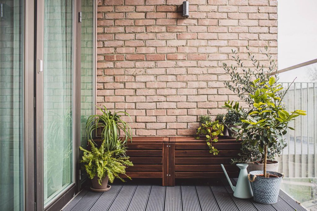 a balcony with a wooden deck and a planter