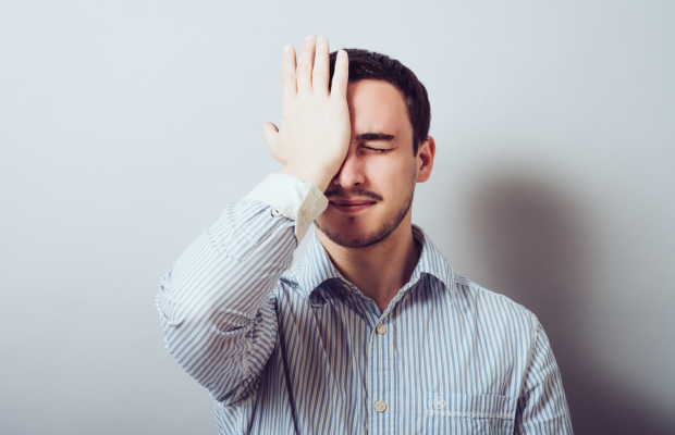 a man with his hand on his head