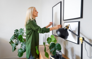 a woman is putting a plant in a pot