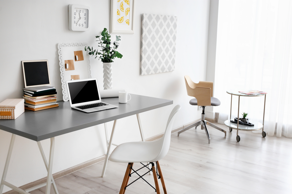 a white desk with a laptop on it