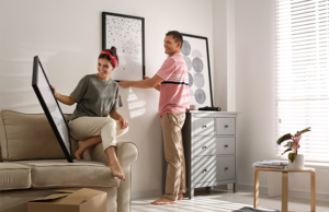 a man and a woman are moving a couch