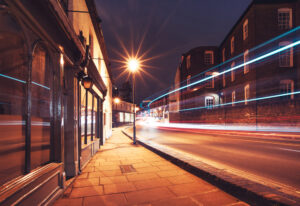 a bus is driving down the street at night