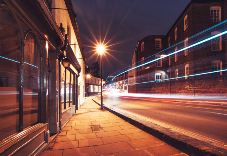 a bus is driving down the street at night