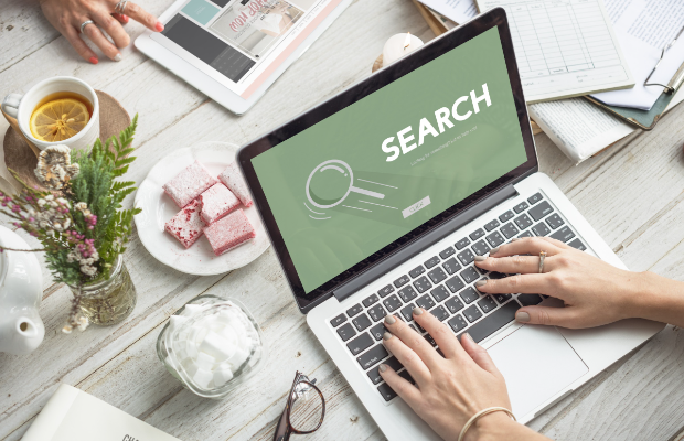 a person using a laptop with search on the screen