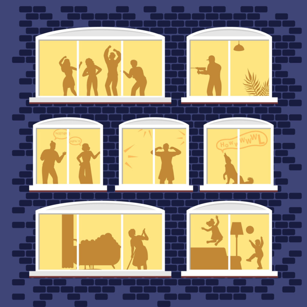Silhouettes of individuals visible in illuminated windows at night.