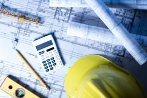 Construction tools and engineering instruments on blueprints.