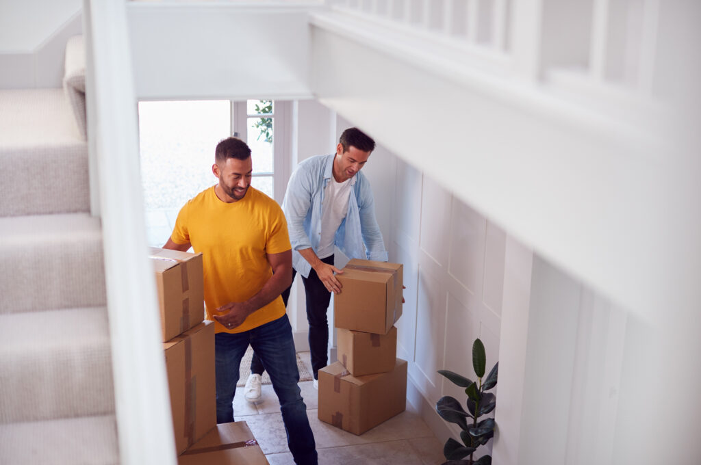 a man and woman moving a house