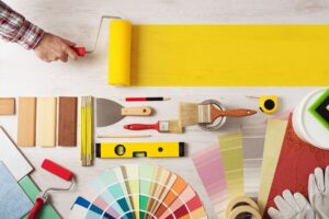 a man is working on a table with paint and tools