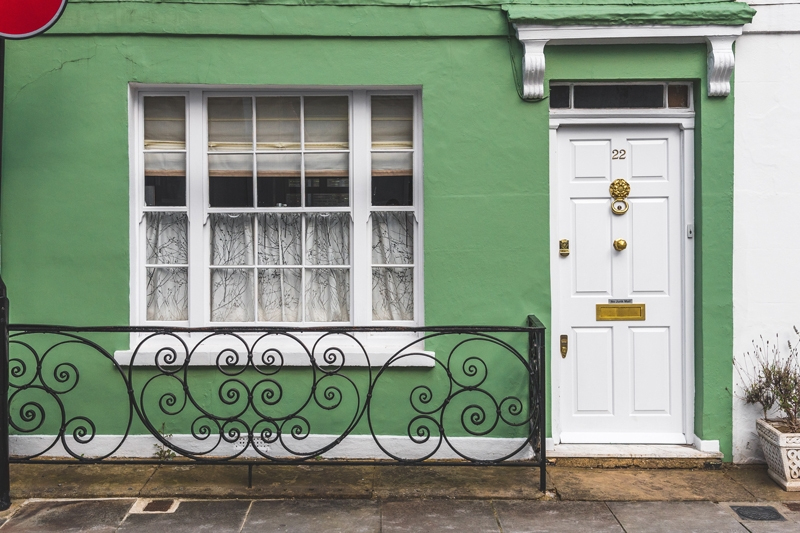 a green house with a white door
