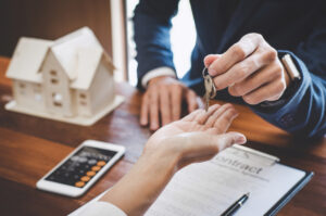 a man signing a document with a woman