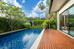 a wooden deck next to a swimming pool