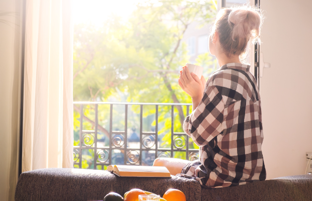 a little girl sitting on a couch with a book