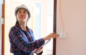 a woman in a room with a wall mounted light