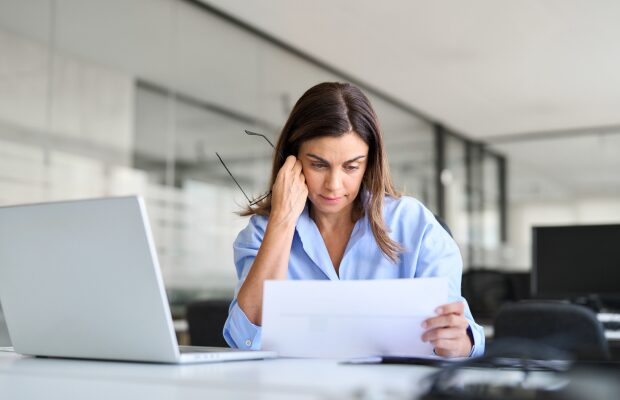 a woman sitting at a desk with a laptop