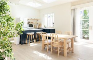 a living room with a dining table and a kitchen