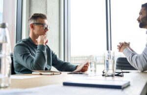 two men sitting at a table