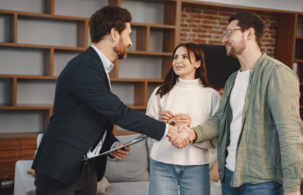 Landlord or letting agent shaking hands with tenant after completing right to rent verification