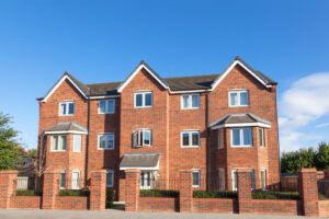 Large brick building with multiple windows and a sturdy facade.
