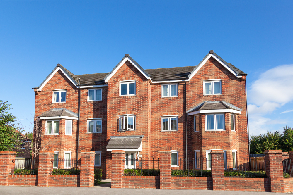 Large brick building with multiple windows and a sturdy facade.