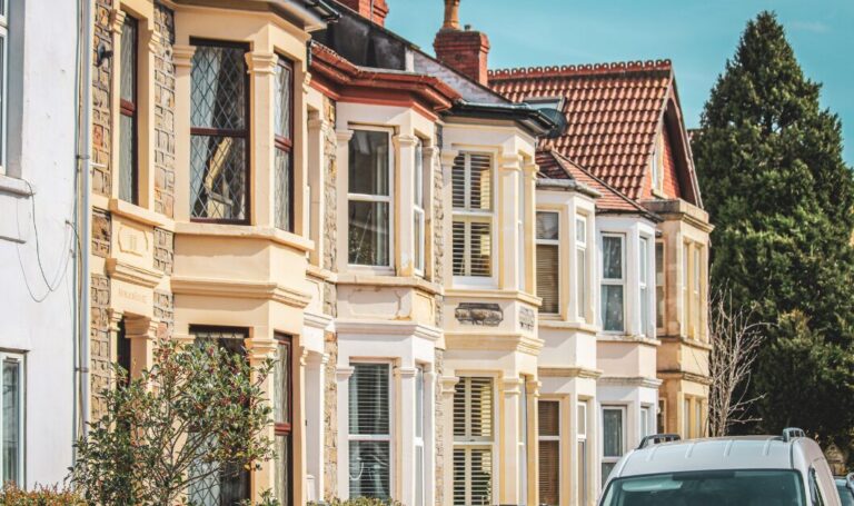Traditional UK terraced houses on a sunny residential street, symbolising the property market in 2026.