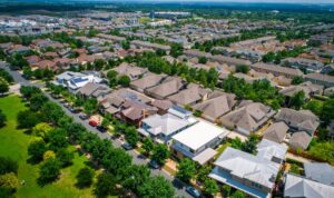 Aerial view of a suburban residential neighbourhood showing family homes and local housing market context.