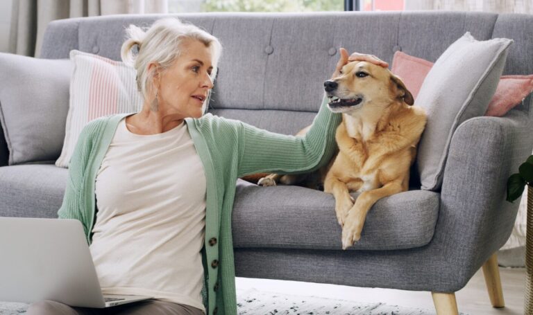 Tenant sitting on the floor beside a sofa stroking her dog in a rental home, reflecting new pet request rules under the Renters’ Rights Act 2025