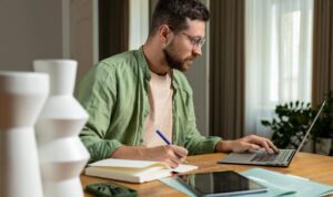 Landlord calculating a rent increase while reviewing documents and market data under the Renters’ Rights Act 2025