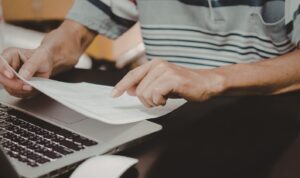 Landlord reviewing tenant applications at desk in modern London flat