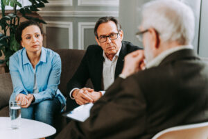 Landlord discussing tenancy agreement and rent terms with tenants in a meeting setting