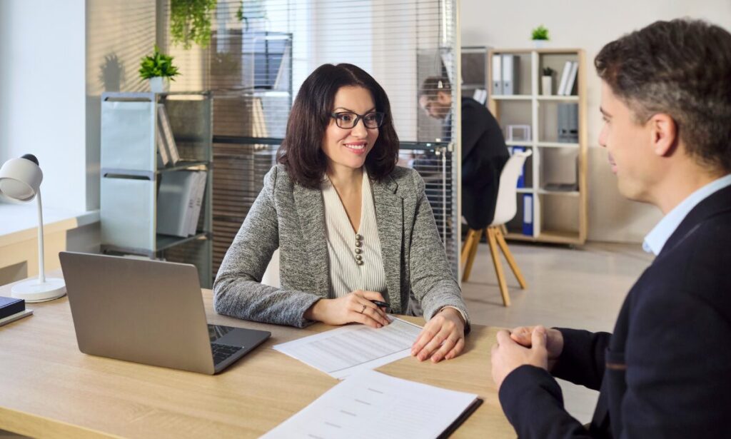 Letting agent discussing rental documents with a landlord, representing Golders Green rental market advice, landlord yields and property compliance.