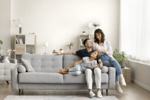 Family relaxing in a bright living room, representing first-time buyers searching for a home in Golders Green.