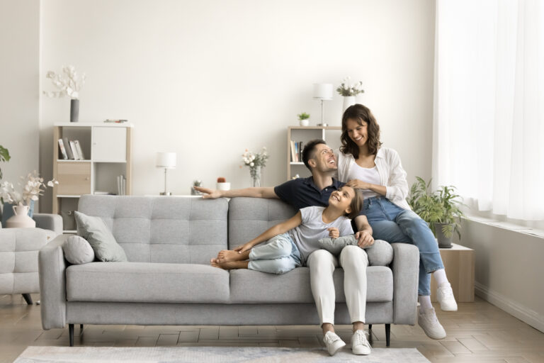 Family relaxing in a bright living room, representing first-time buyers searching for a home in Golders Green.