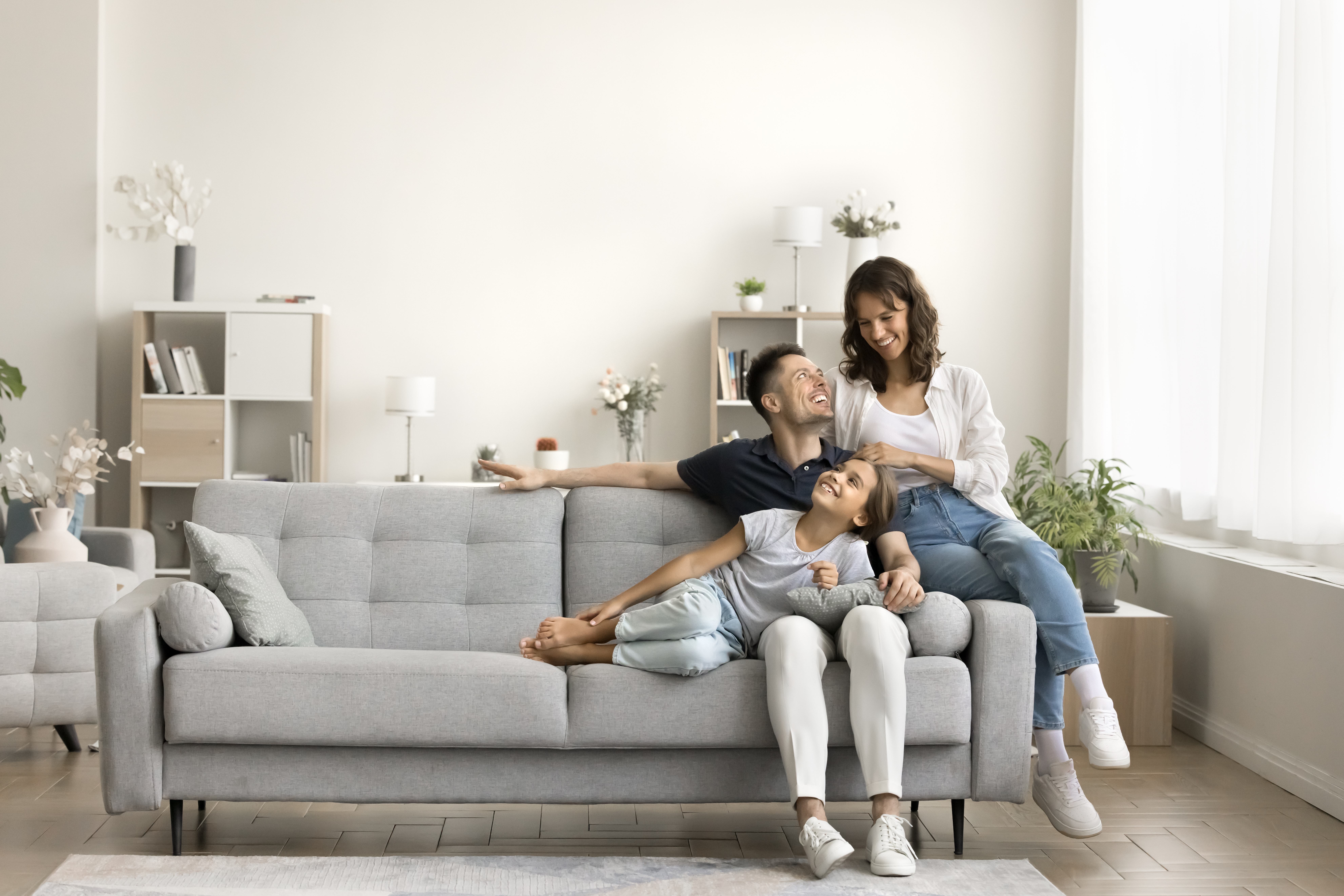 Family relaxing in a bright living room, representing first-time buyers searching for a home in Golders Green.